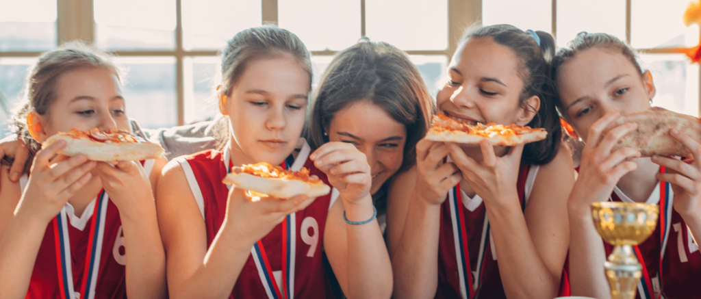 A sports team celebrating victory with Bertucci's pizza