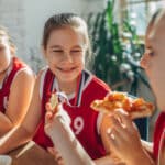 Kids with their sports team eating Bertucci's pizza