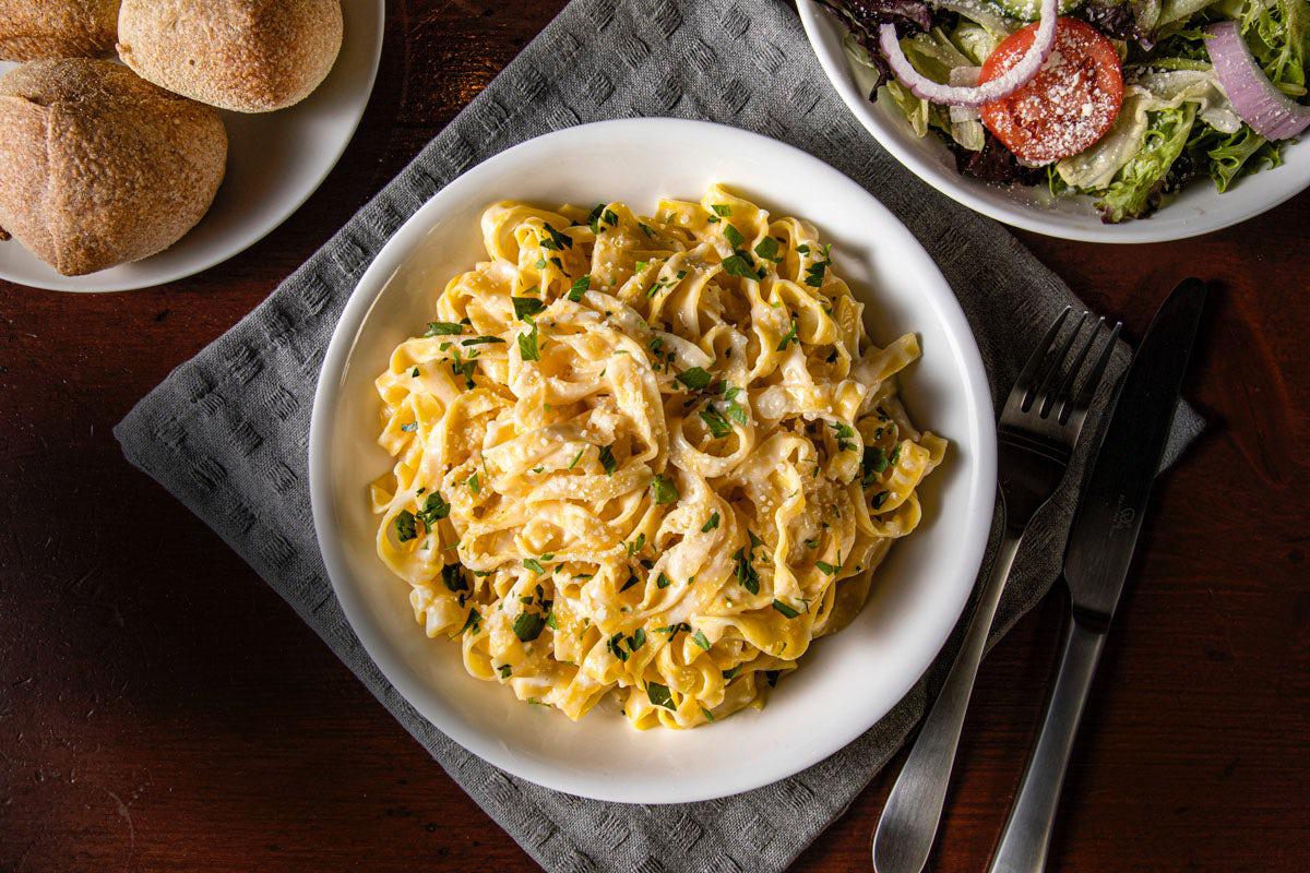 Bertucci's Fettuccine Alfredo bowl with side of Insalata salad and rolls