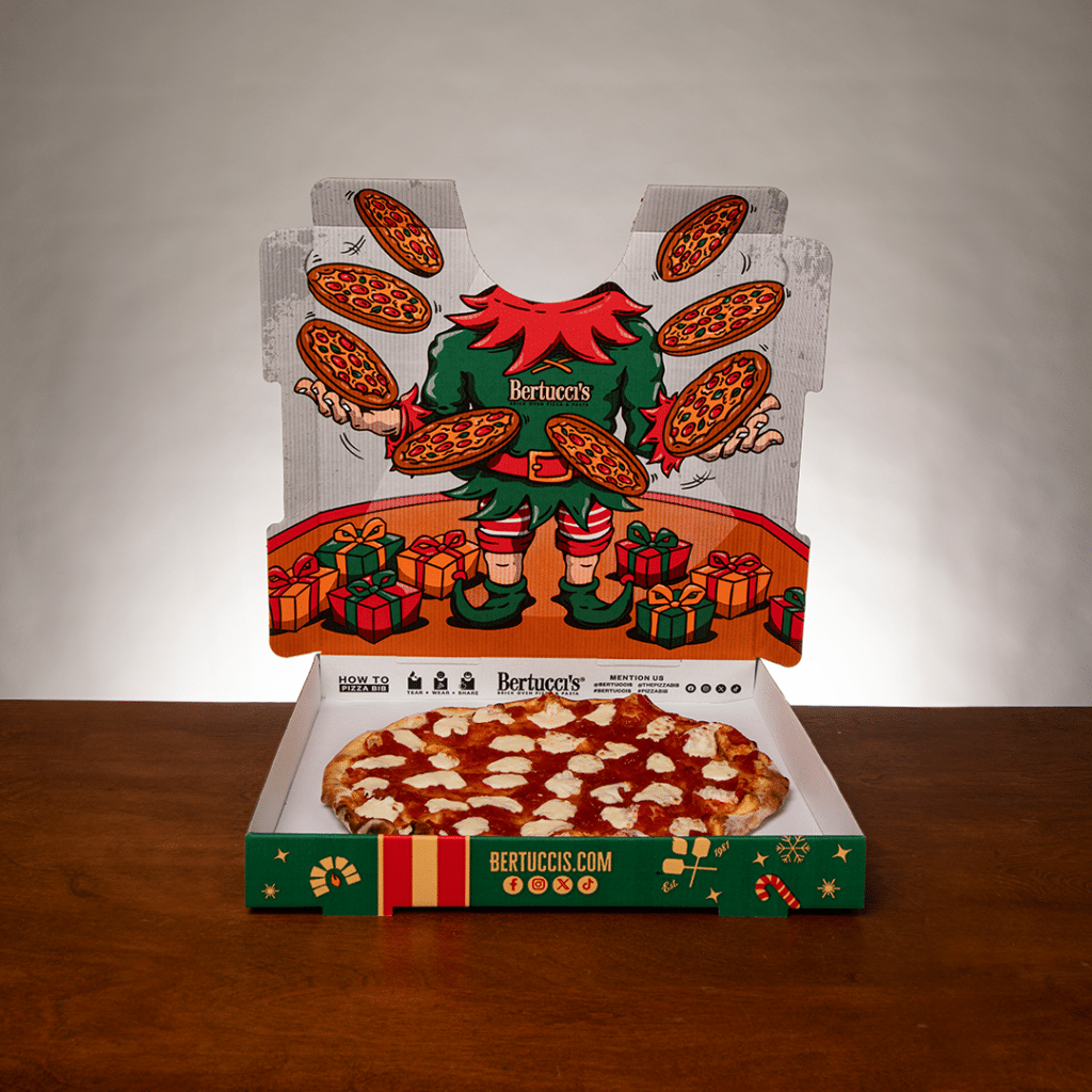 A pizza box with an illustration of a juggling elf on the inside of the lid