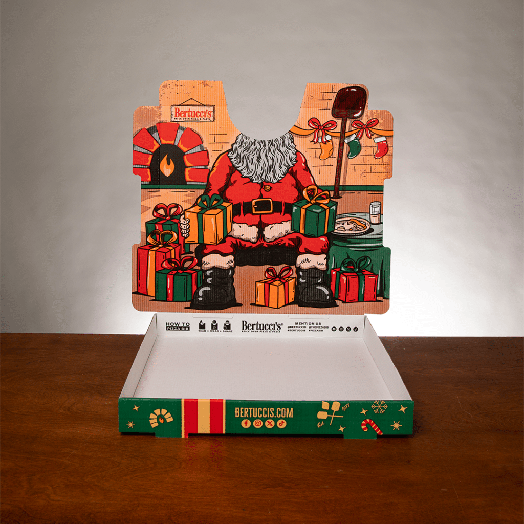 A pizza box with an illustration of Santa printed inside the lid