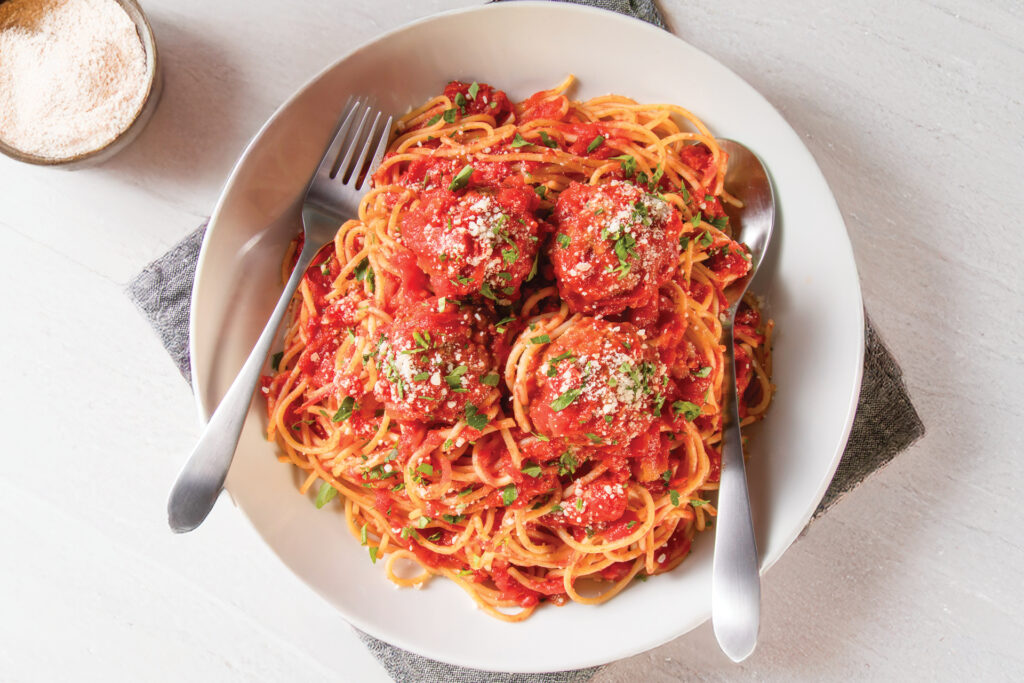 Spaghetti and meatballs in a white bowl