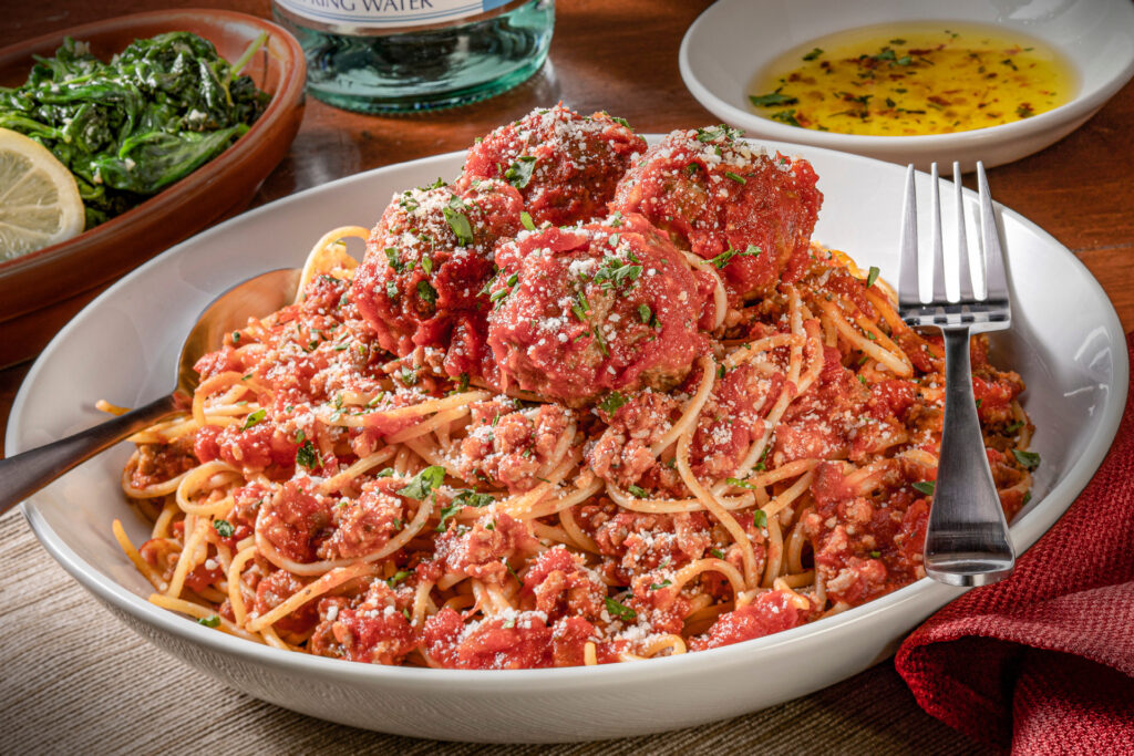 A large bowl of spaghetti and meatballs