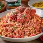 A large bowl of spaghetti and meatballs
