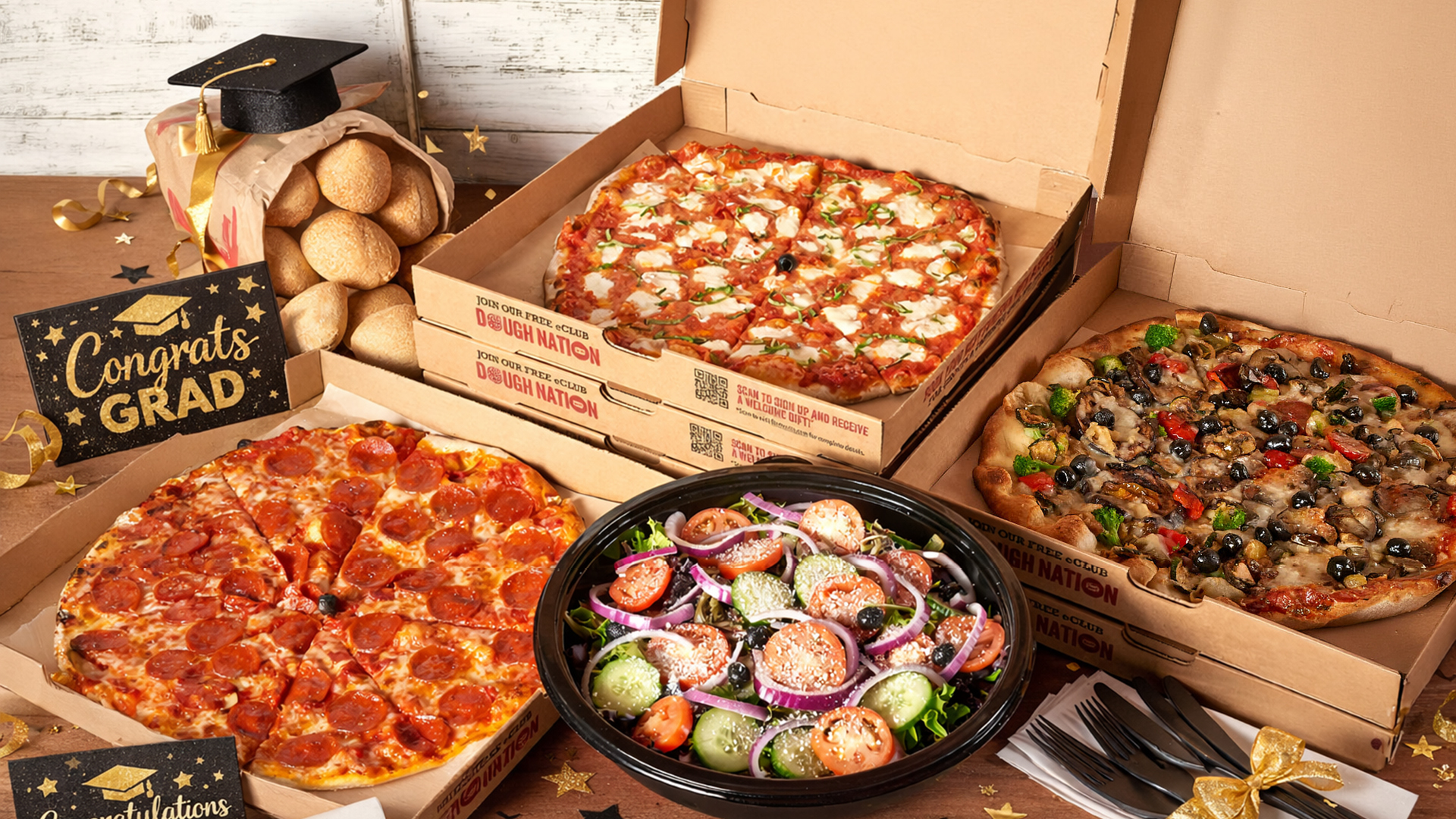 Bertucci's catering pizzas with graduation signs and graduation caps