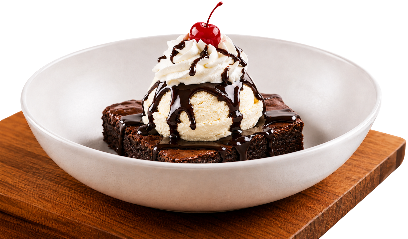Bertucci’s brownie sundae with vanilla ice cream, chocolate sauce, whipped cream, and a cherry served in a white bowl on a wooden board.