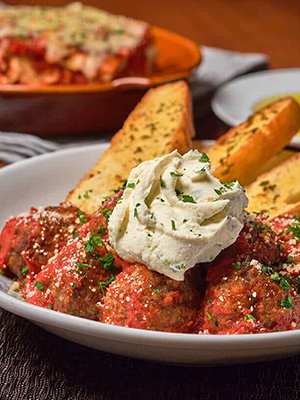 Bertucci's meatball appetizer topped with house-made pomodoro & whipped ricotta. Served with artisan flatbread